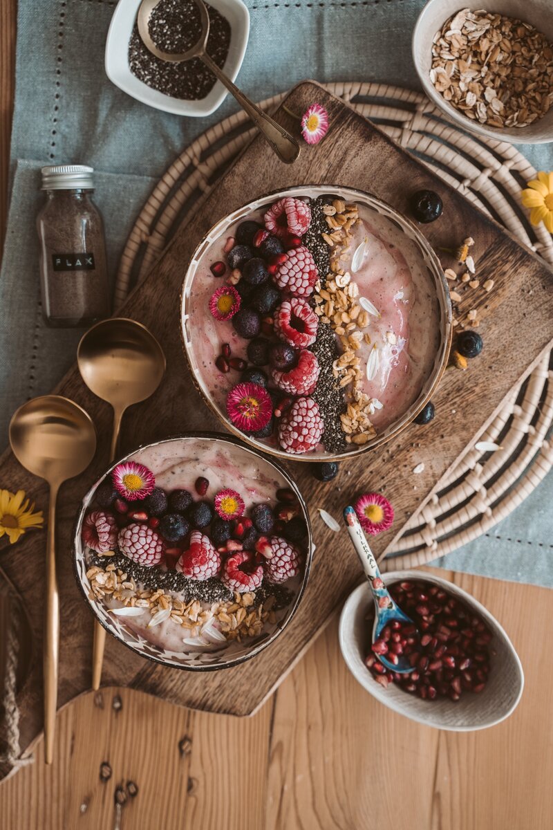 Smoothie bowls with frozen fruit and seeds