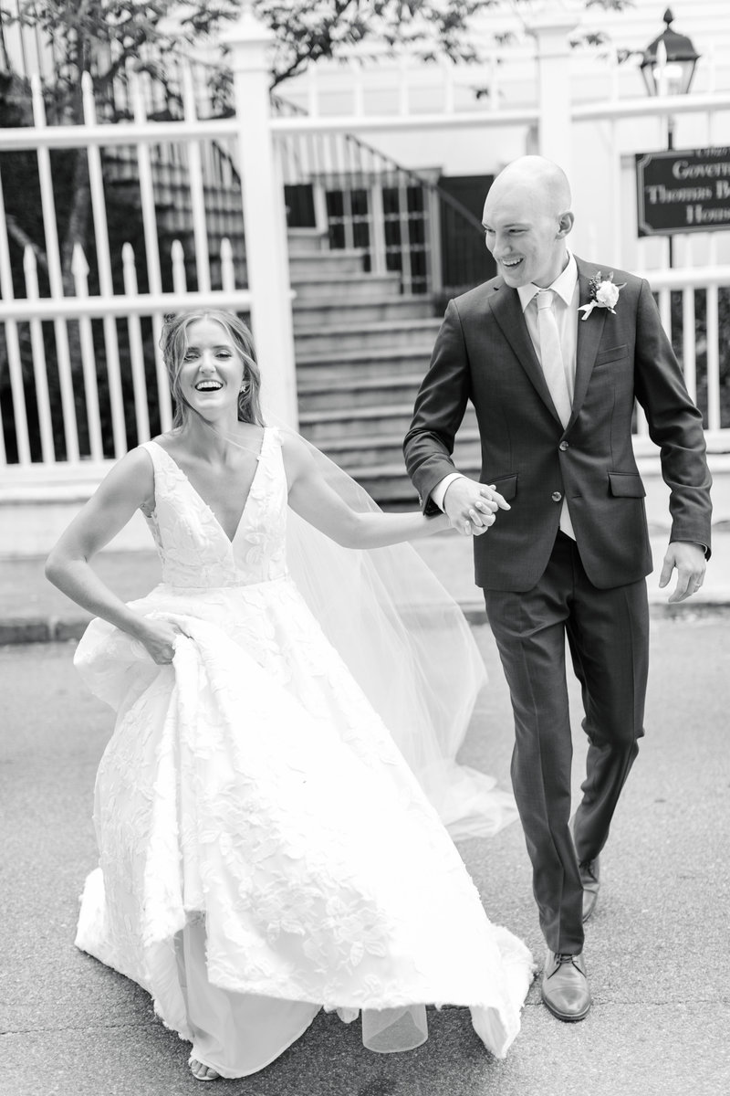 Bride and groom running through the street on their wedding day at Governor Thomas Bennett House in Charleston South Carolina