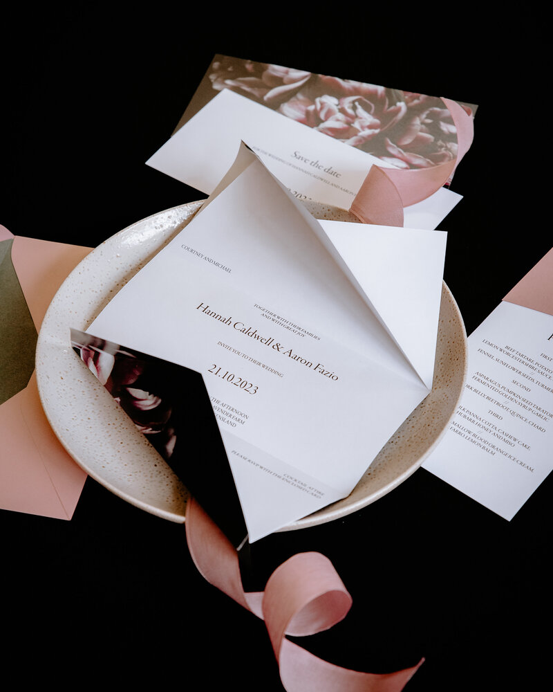 Classic unfolded origami wedding invites with  pink flowers and minimalist design