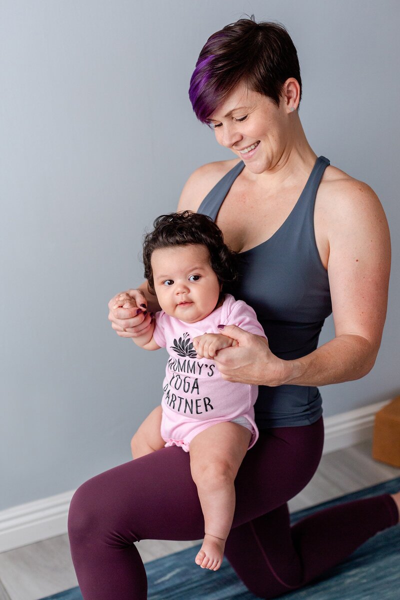LA yoga instructor poses for brand photo with baby on her knee