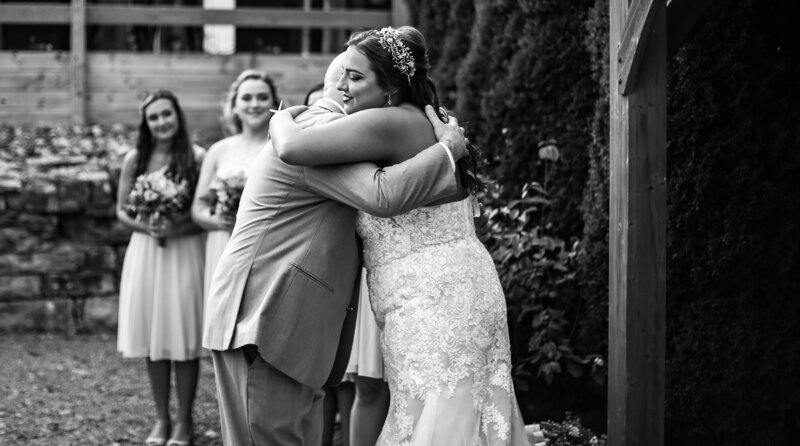 Bride hugs father as he gives her away during Port Farms wedding ceremony