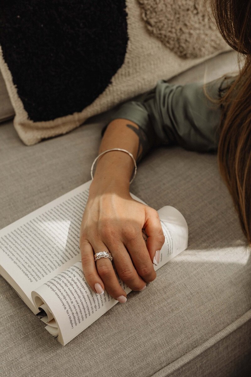 kaboompics_hands-silver-jewelry-bracelet-rings-book-32274