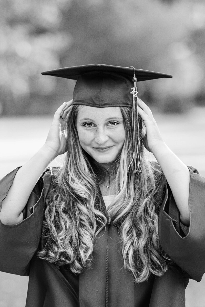 Black and white photo of a OPRF HS senior holding her cap