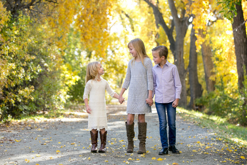 Two sisters and brother walking down Cherry Creek path