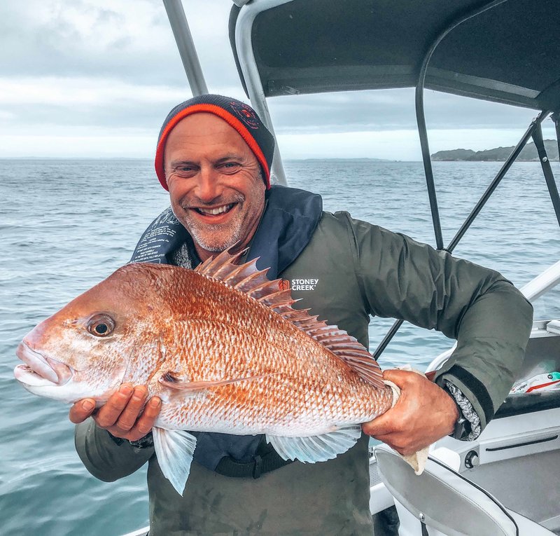 Warren holding the snapper he caught on north island fishing trip, new zealand