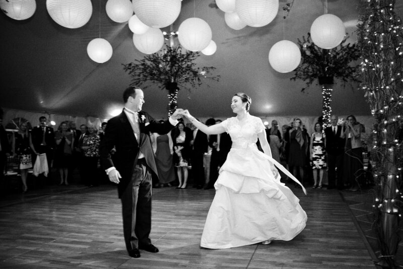 A couple dances in a tent for their wedding