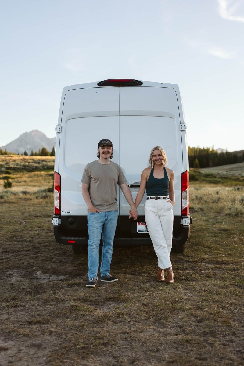 Lauren and Matt of Intimate Adventures Media standing in front of the Sawtooth Mountains in Stanley, Idaho after a wedding shoot