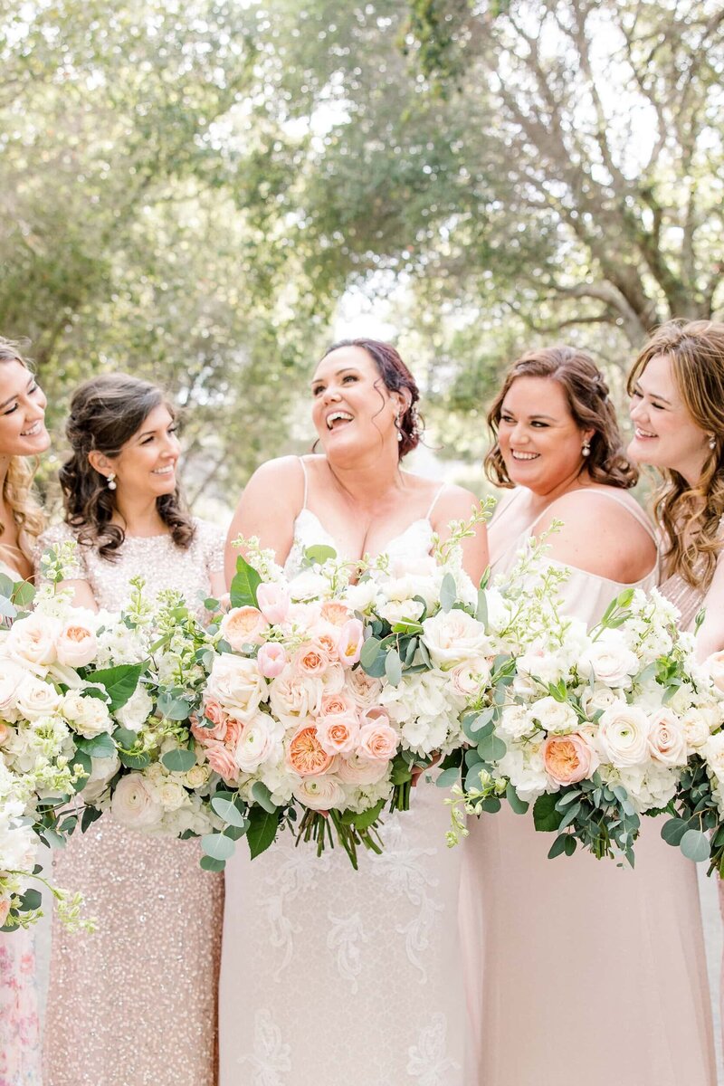 Bride with bridesmaids in peach and champagne