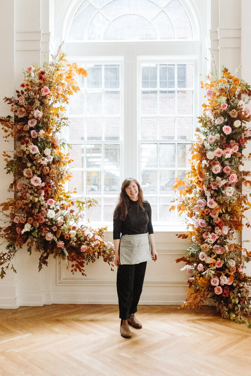 Mary Love Richardson, Rosemary and finch floral design company owner and founder, wedding and event floral design in Nashville, TN and travel flowers. Ceremony floating arch fall wedding florals in hues in taupe, burnt orange, burgundy, copper, dusty pink, and mauve.