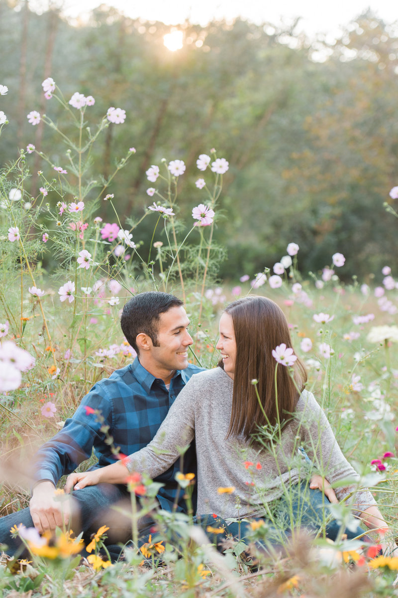 Biltmore engagement photos, couple poses at Biltmore for engagement photo, sitting in flowers
