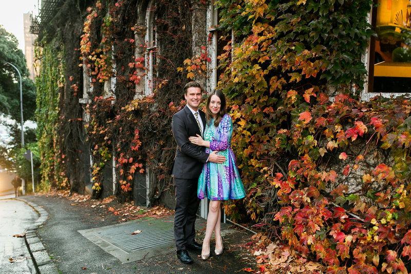 couple on street in front of ivy covered building
