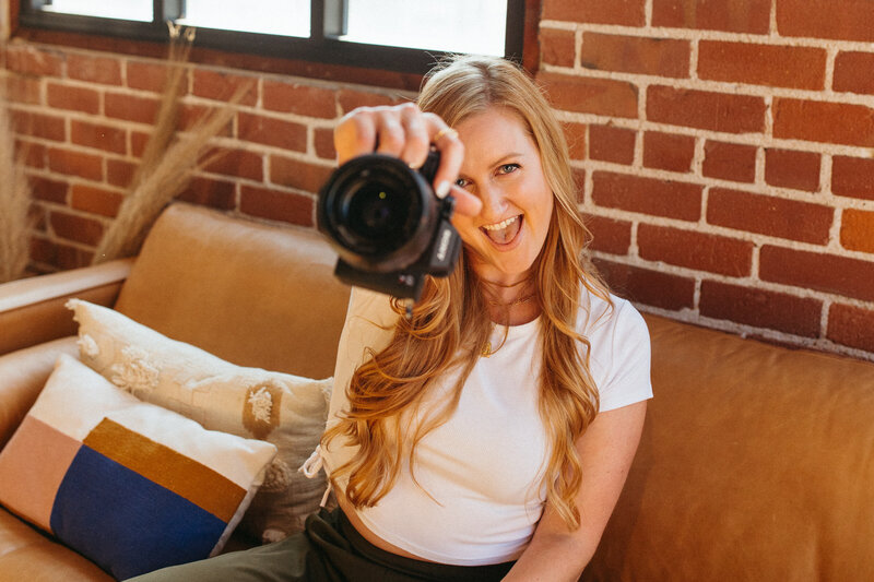 woman holds up camera