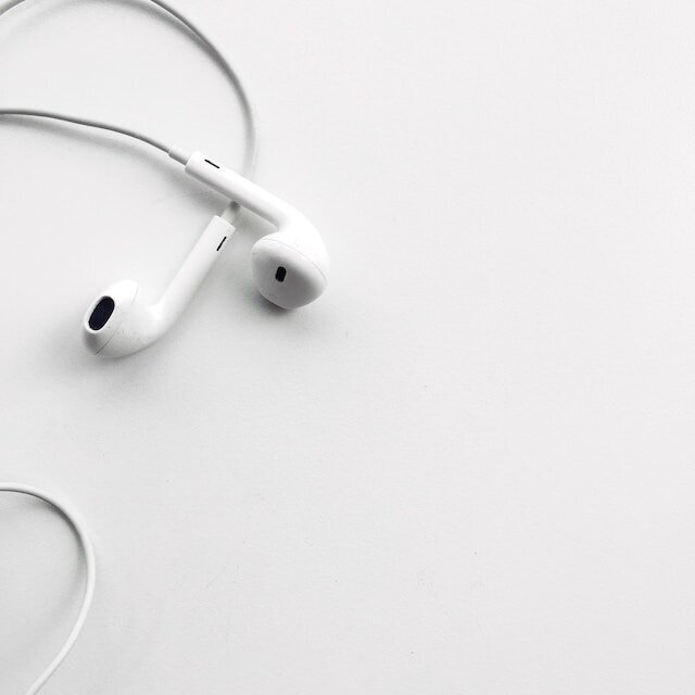 white headphones on a white surface