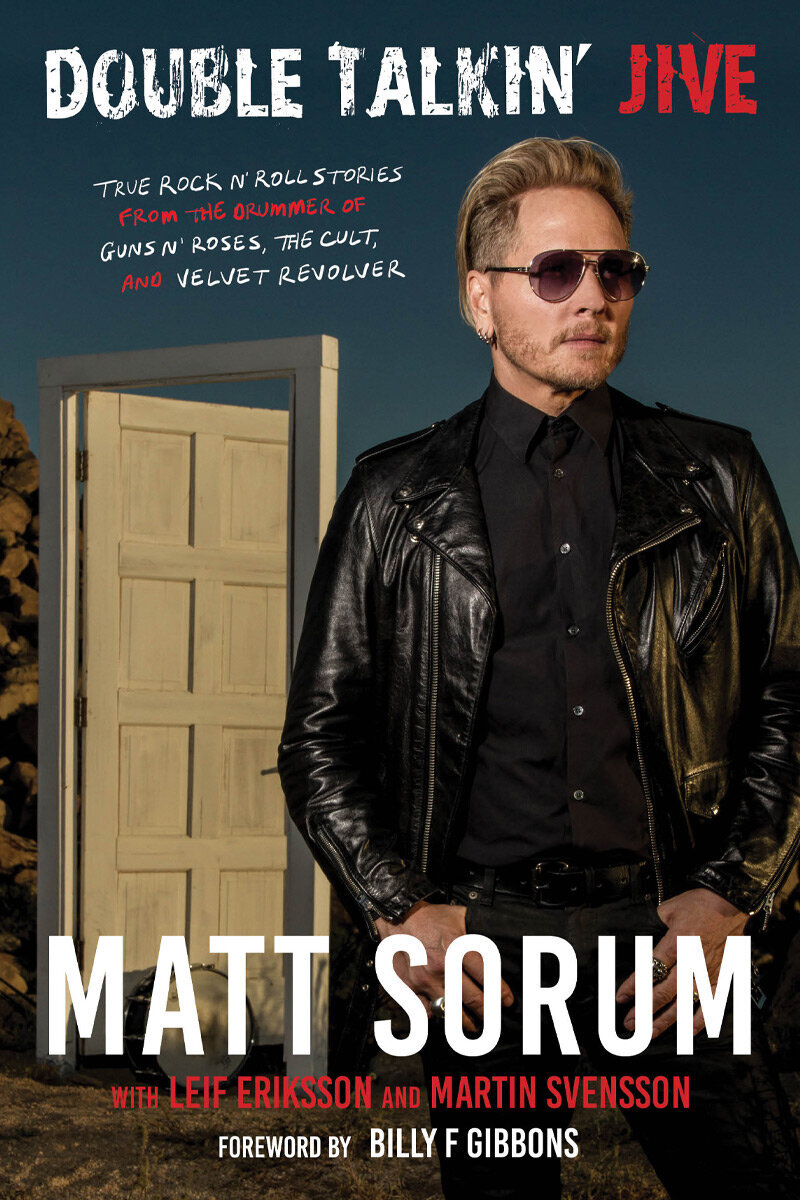 Matt Sorum Double Talkin Jive Autobiography Cover Portrait standing in front of free standing door in desert