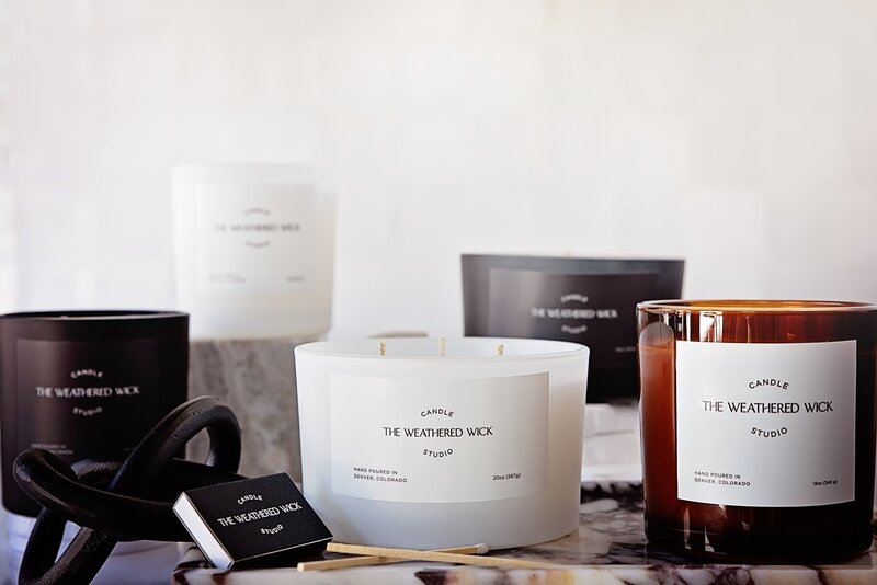 black candles and diffuser on wood table