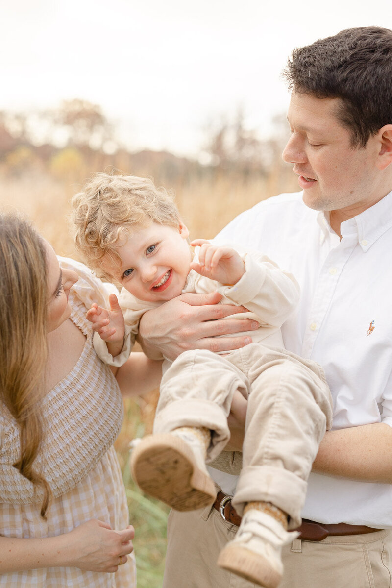 Parents playing with son during photos in Manassas, Virginia