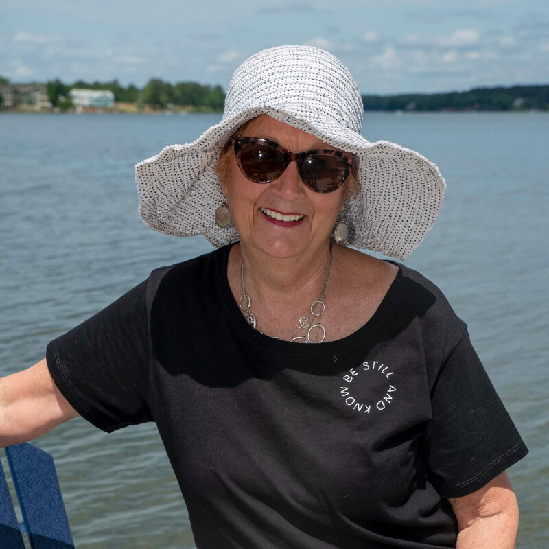Jane, blogger behind Positively Jane, at the beach or lake living life joyfully