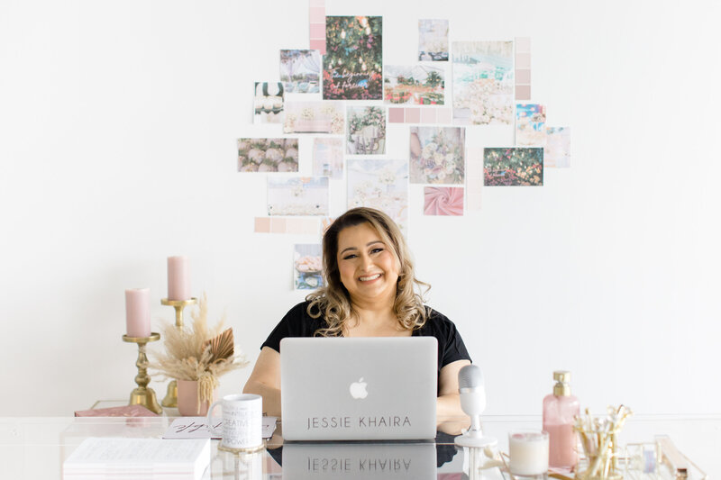 sikh wedding planner jessie khaira smiling behind grey macbook in front of collage of images