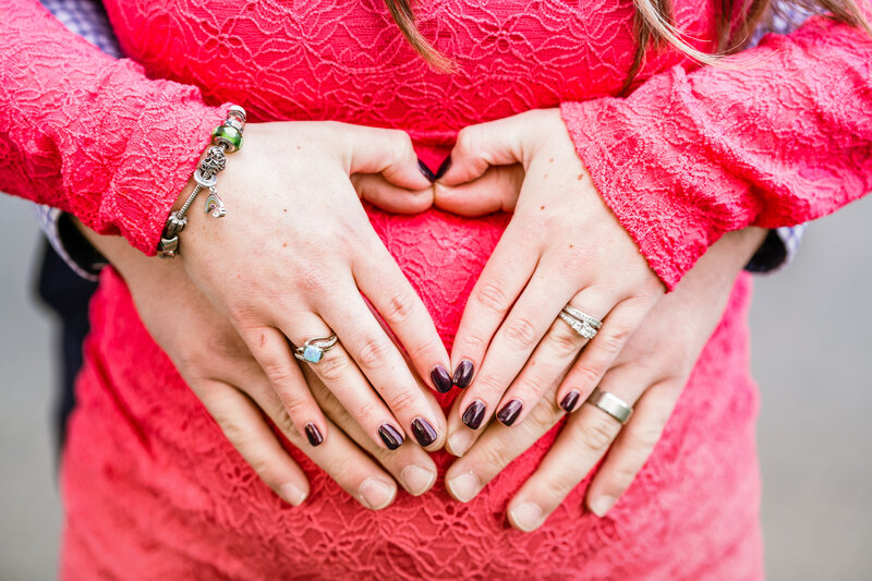 Maternity session close up of heart hands