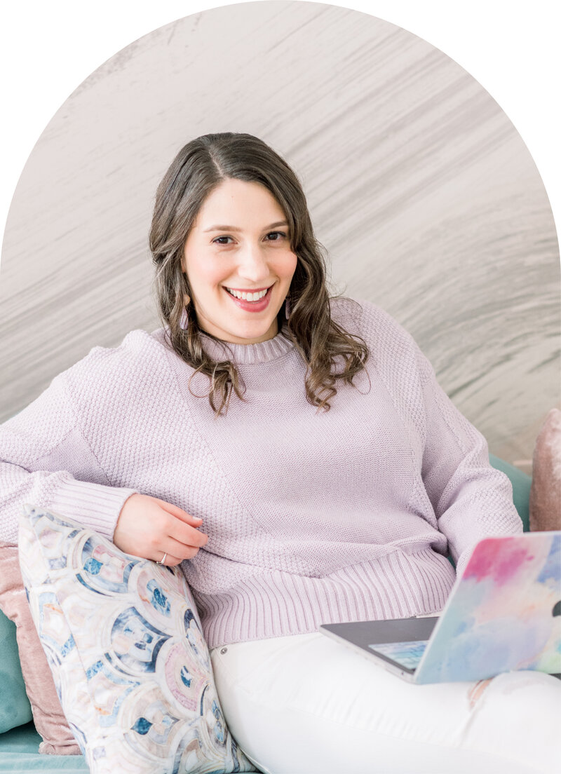 Isabel Kateman, website designer and strategist, sitting on a couch and working on a client's website