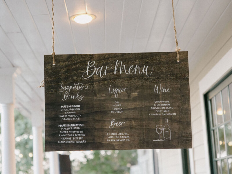 Custom hanging wooden bar sign with the bar menu handwritten