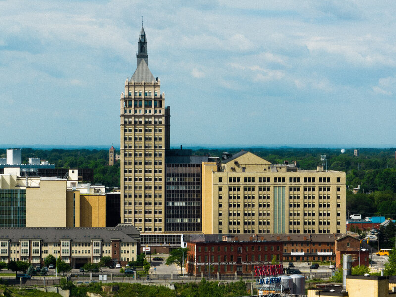Downtown skyline featuring historic Art Deco building under bright clouds – photographed by wedding photographer Niko Coric – Lumen Clarity Media
