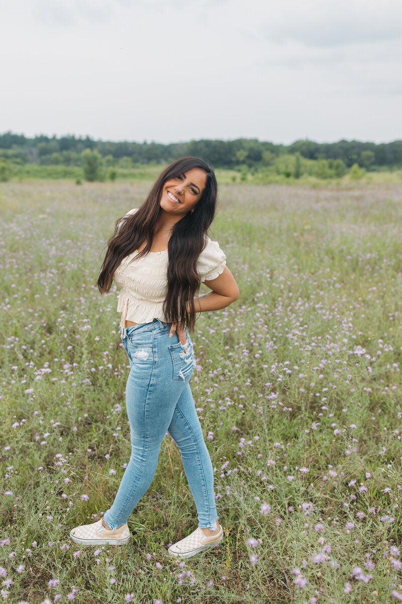 Woman leaning against a wall smiling