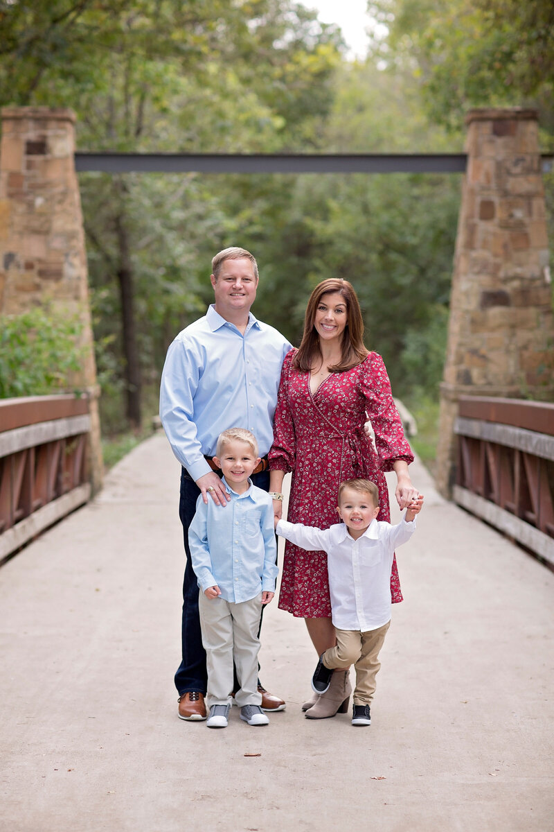 Family Portrait of Father, Mother and two boys on a bridge