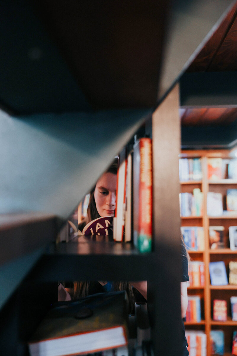 KP reads a book on a shelf