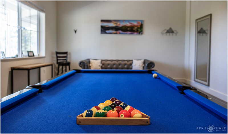 Blue felt pool table inside groom's room at Woodlands Barn in Colorado