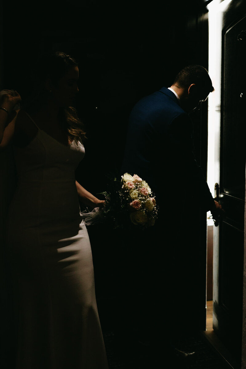 Bride and groom open door