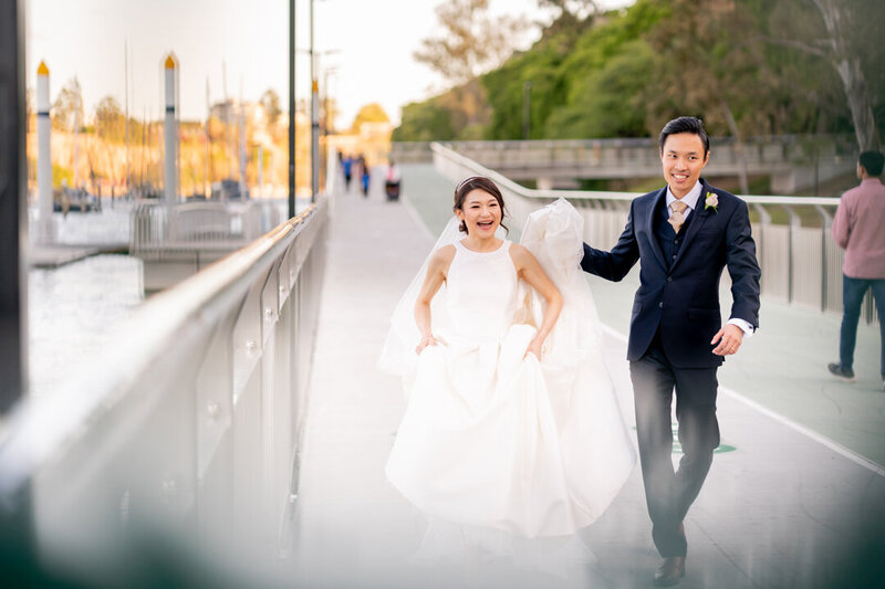Happy Bride and Groom runs on the road