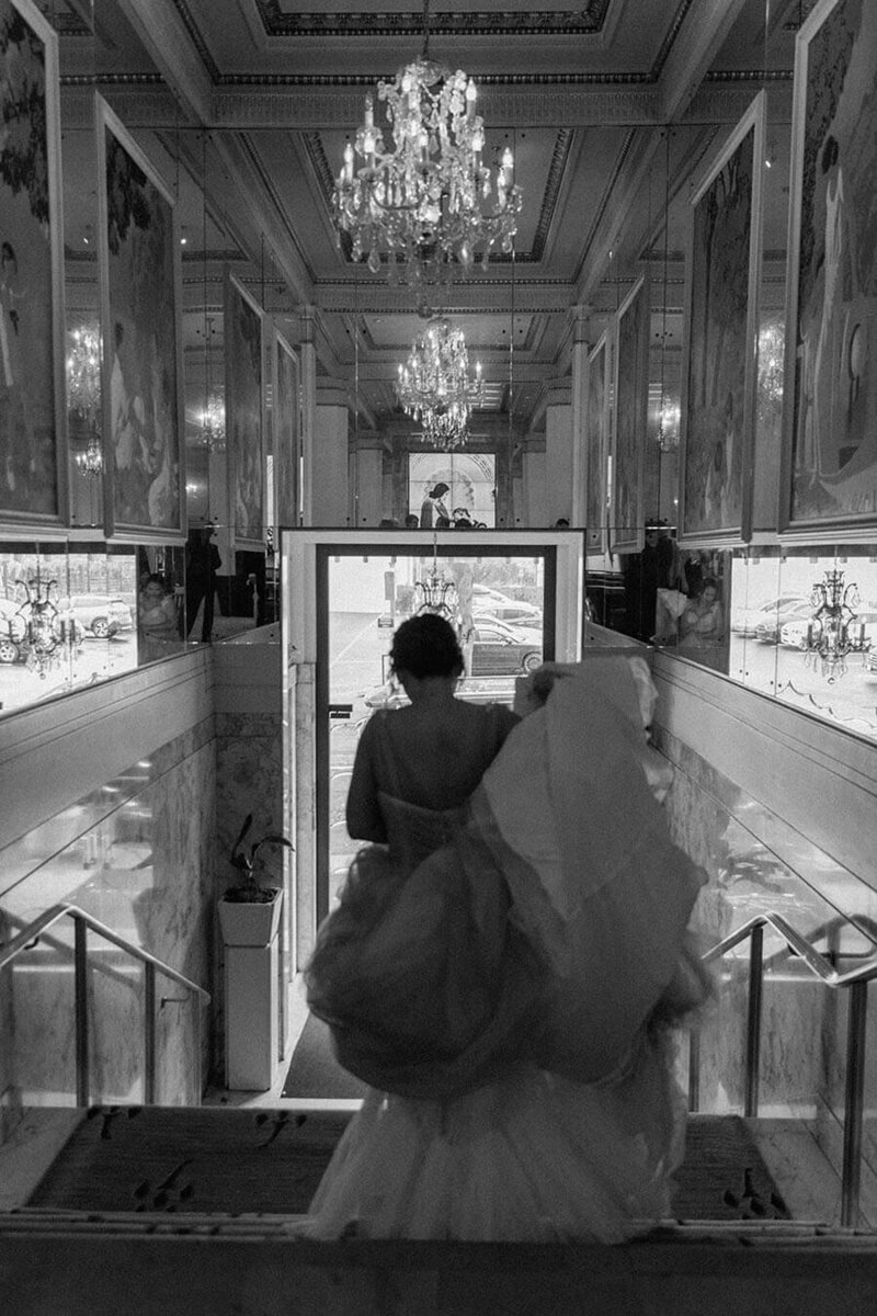 bride walks down stairs in luxury downtown hotel portland oregon