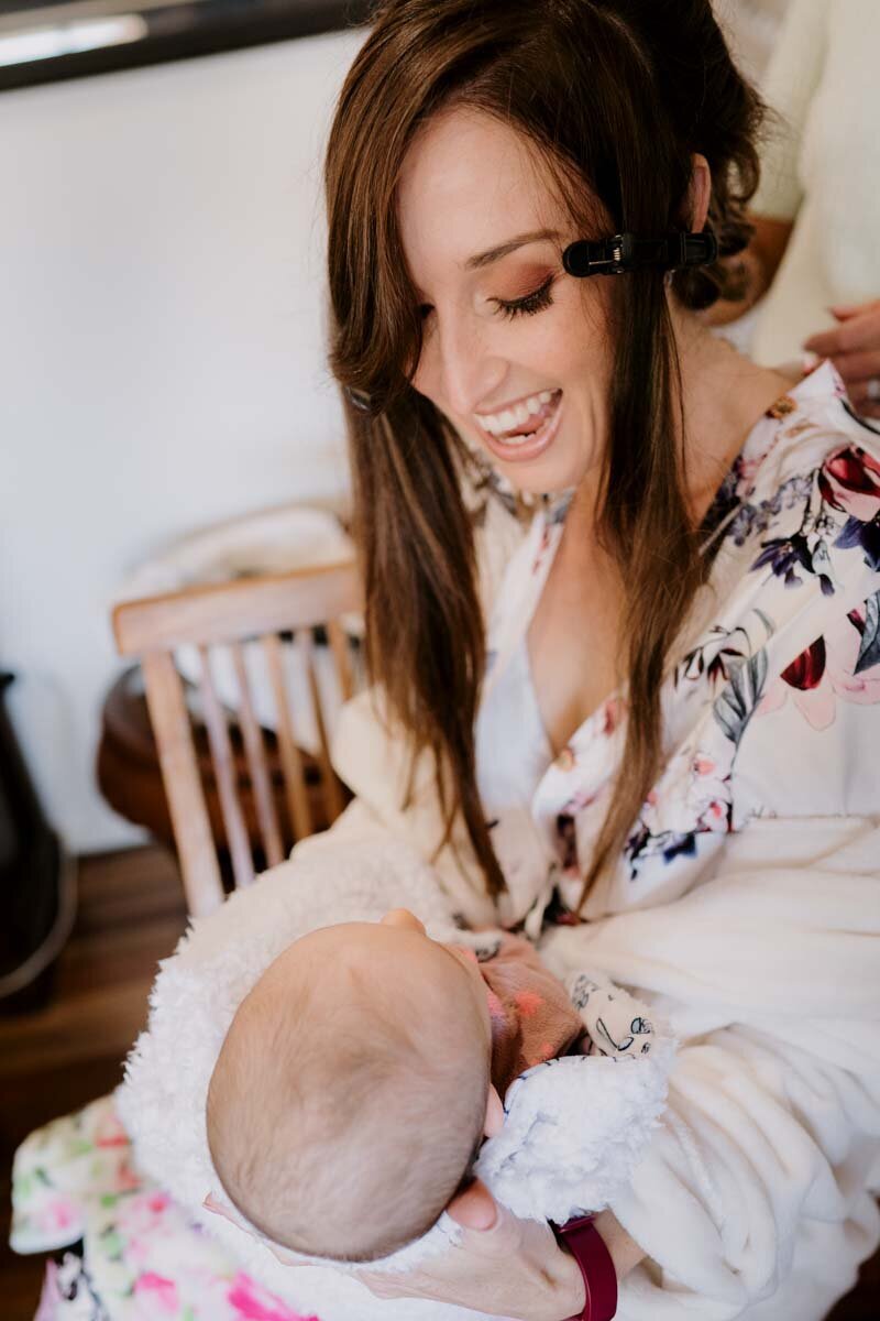 Bride holding her newborn baby
