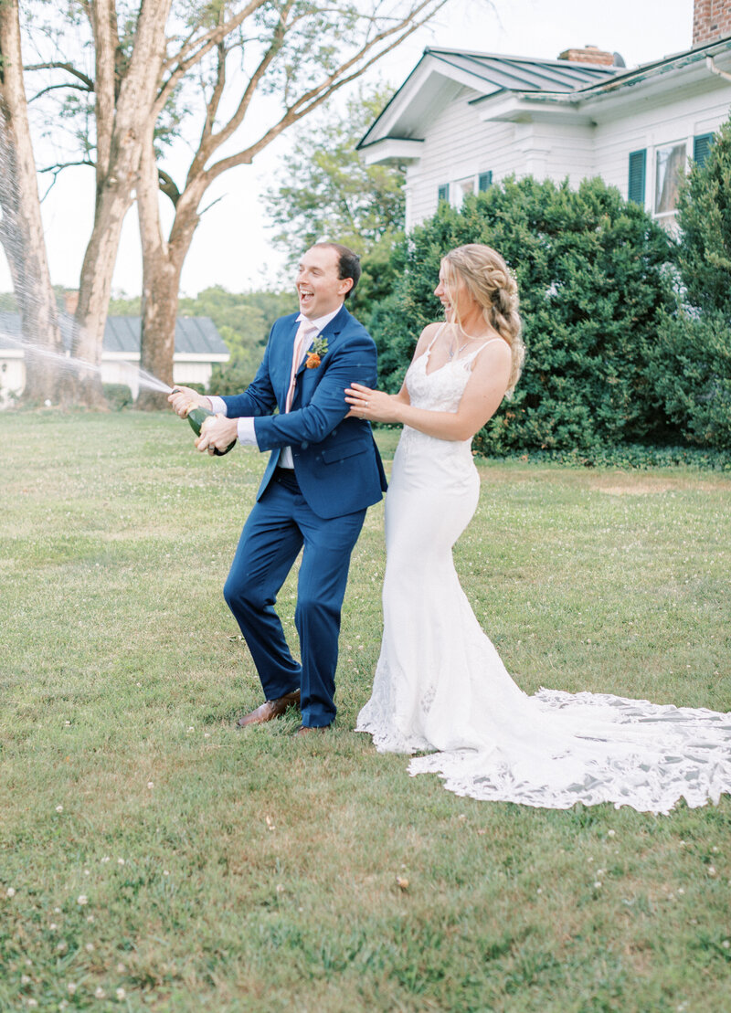 Couple pop champagne  by Rachel Jordan Photography Virginia Wedding Photographer