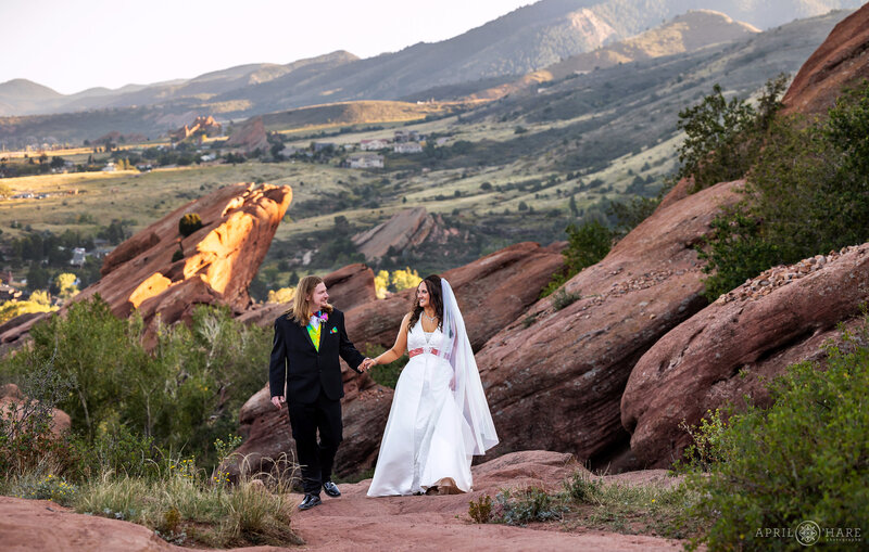 Couple walk along the Trading Post Trail at their Red Rocks Wedding in Colorado
