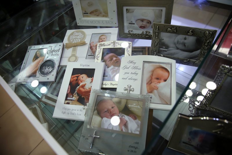 Selection of frames for babies in display case. By Ross Photography, Trinidad, W.I..