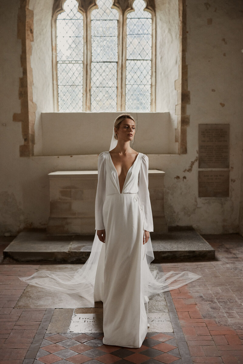 Sustainable wedding dress handmade in silk from british designer on bride in chapel