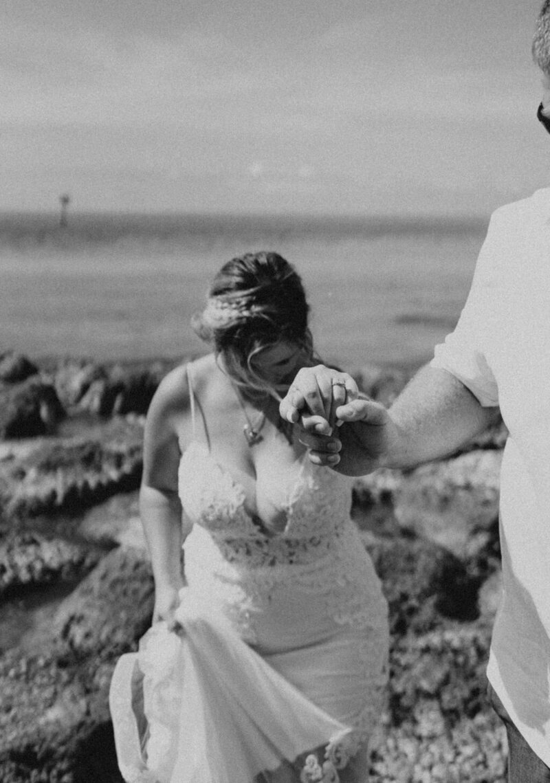 bride holding husbands hand in key west florida