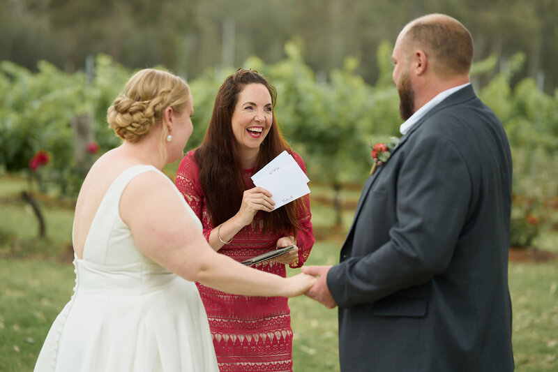 Celebrant handing vow cards to wedding couple