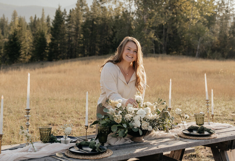 Sydney Breann poses as she puts together a tablescape near Glacier National Park.