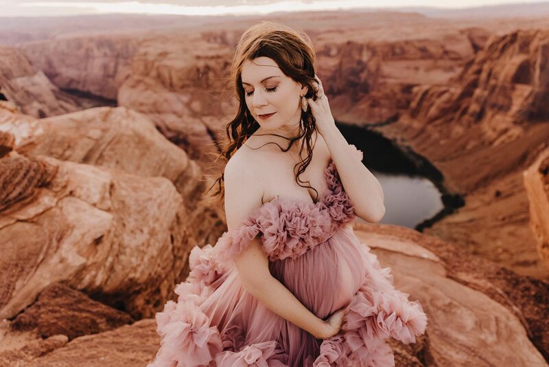 maternity photograph of woman in elegant gown at horeshoe bend arizona