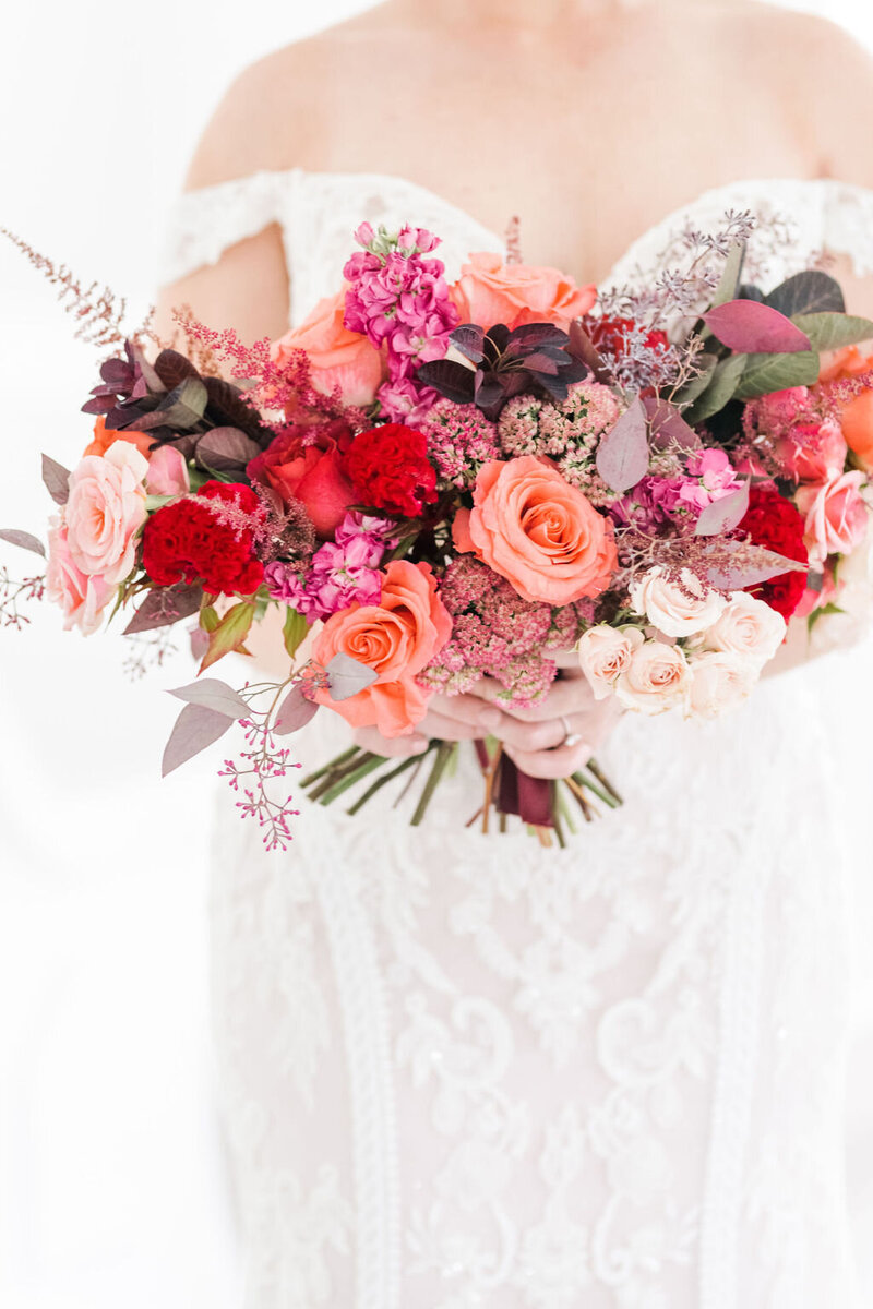 Boho wedding decor. Trendy flower bouquet in moody and chic setting.