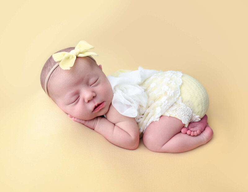Newborn girl posed in bum up at our studio in Rochester, Ny.