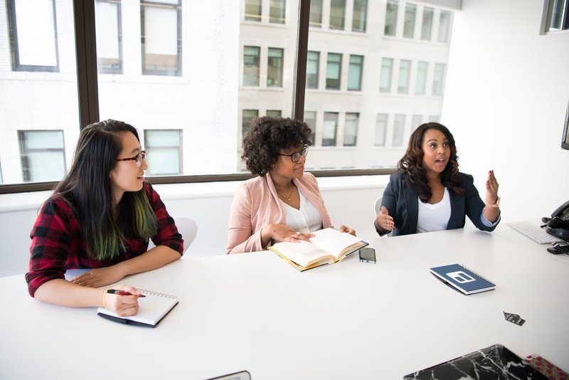 three-women-in-front-of-desk-1181618
