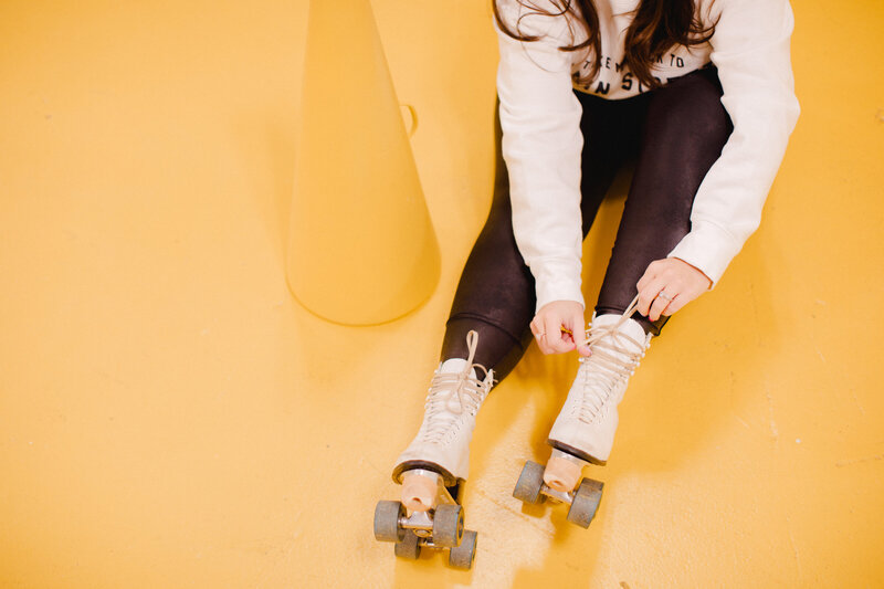 Woman Tying Laces on Roller Skates