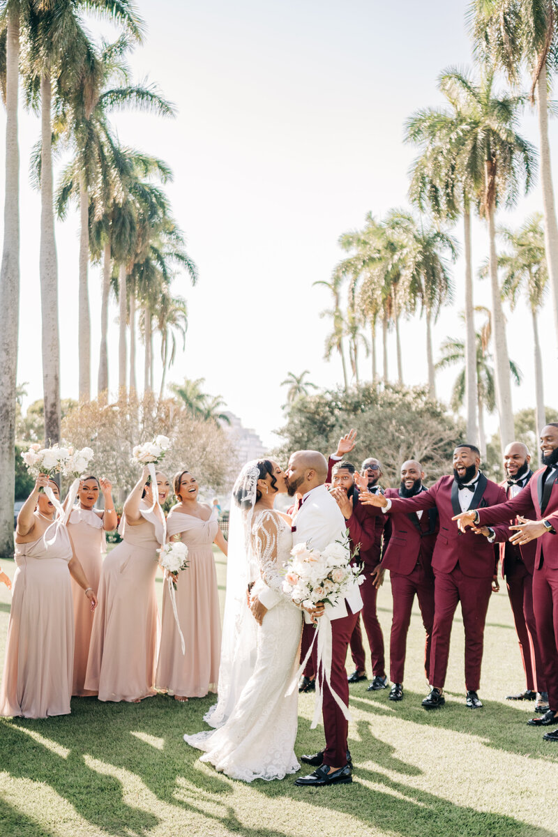 Palm Beach Wedding Photographer captures bride and groom celebrating with their wedding party