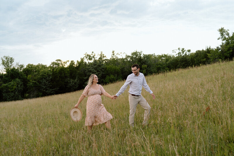 Outdoor, natural maternity session at Shawnee Mission Park in large prairie fields.