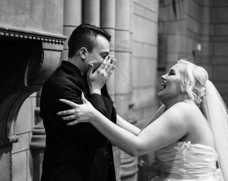 Groom reacts when he sees his bride in her dress at the Cathedral of Learning in Pittsburgh, PA
