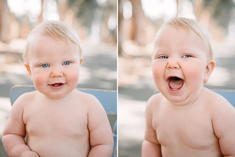A child with blue eyes and chubby cheeks laughs and smiles at the camera